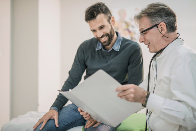 Doctor Showing Medical Chart to Patient